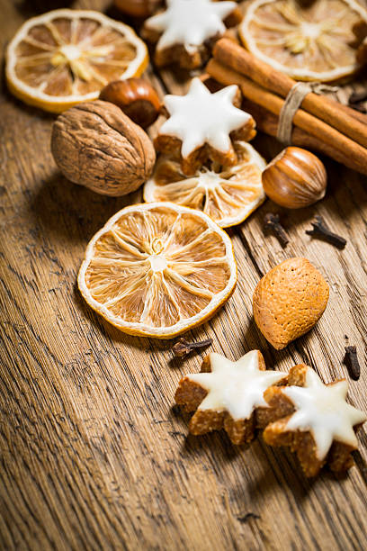 istock Dried citrus slices, spices, and nuts on a rustic wooden table create a festive atmosphere for holiday baking and decoration 2206793715