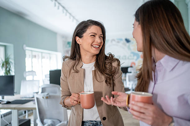 istock Two businesswomen chatting and laughing during coffee break 2206794758