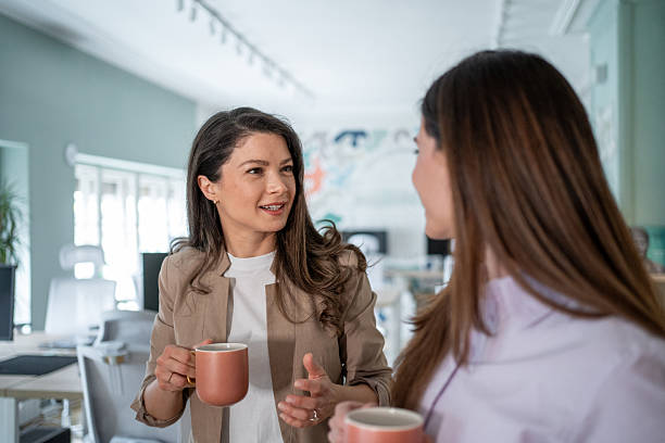 istock Two businesswomen talking during coffee break in office 2206794773