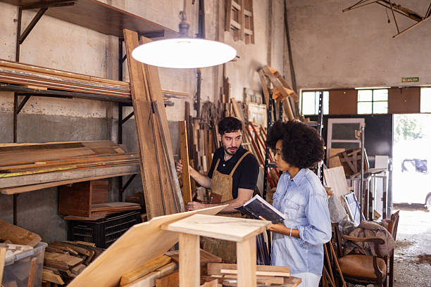 istock Two Individuals Collaborating in a Sustainable Woodworking Workshop Setting 2206795623