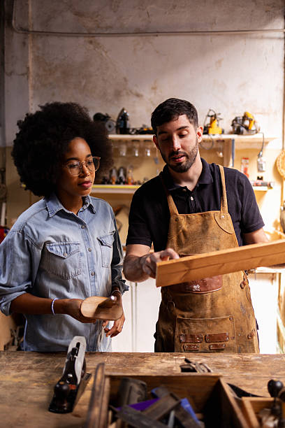 istock Artisan instructors working together in a sustainable woodworking workshop 2206795626