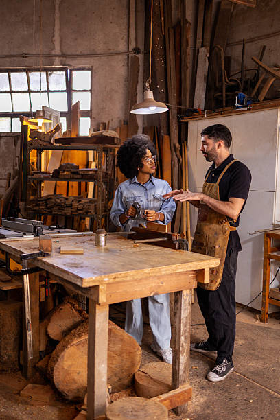 istock Craftspeople Collaborating in a Sustainable Woodworking Workshop 2206795673