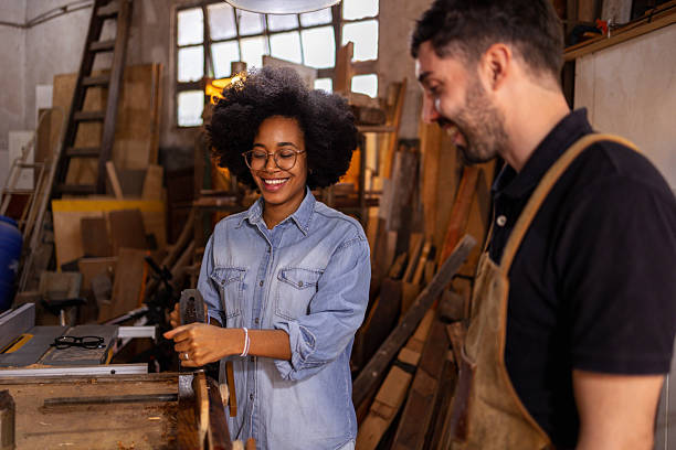 istock Two colleagues collaborating on a project in a sustainable wood workshop 2206795678