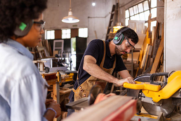 istock Carpenter operating machinery in a sustainable woodworking workshop with focused precision 2206795704