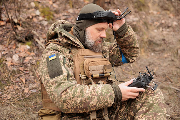 Army operator in FPV glasses controls drone with bomb to drop to enemy.