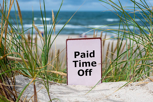 istock Sign at the beach with the text 'paid time off'. 2206797752