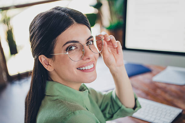 istock Confident young woman in elegant blouse working at office desk, looking at camera with cheerful smile 2206797901