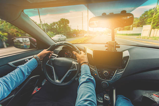 Close up of driver holding the steering wheel while driving at high speed