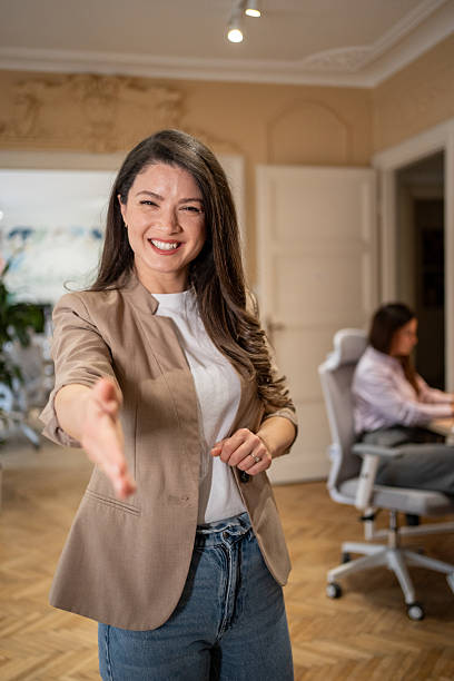 istock Smiling businesswoman extending hand for handshake in office 2206799068