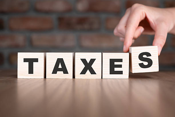 istock Taxes word with wooden blocks on table 2206799165