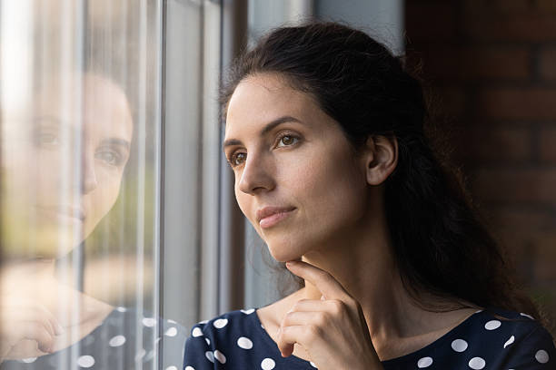 istock Close up dreamy woman looking out window, visualizing future 2206800383