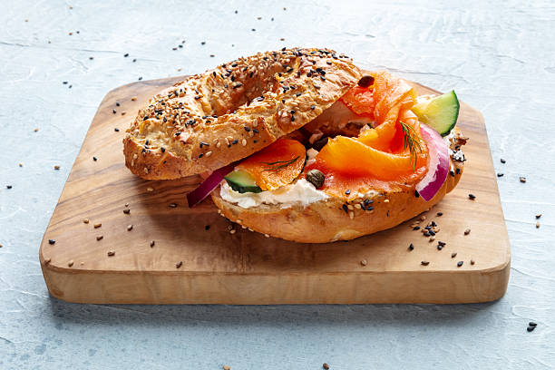 istock Lox bagel. A sandwich with smoked salmon and fresh vegetables 2206802351