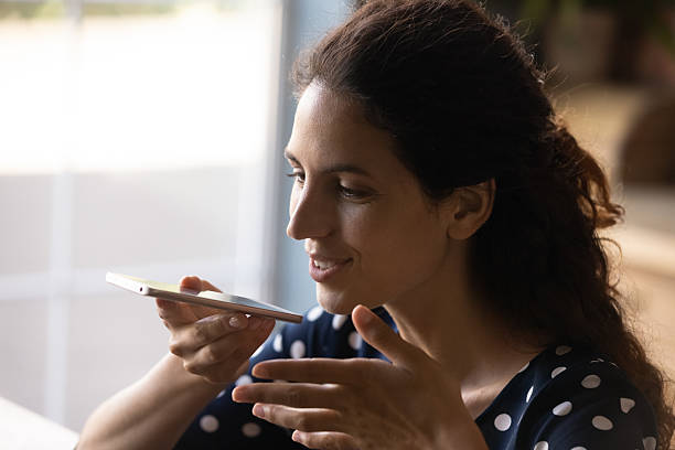 istock Close up smiling woman recording audio voice message, using smartphone 2206802478