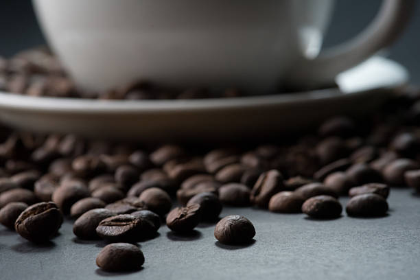 coffee in white cup and coffee beans are the background.