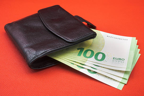 Spending and saving, euro banknotes in your wallet.