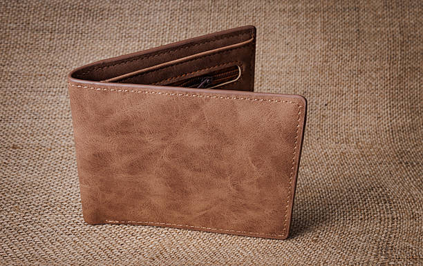 istock A beautiful leather wallet lies on a wooden surface. 2206806610