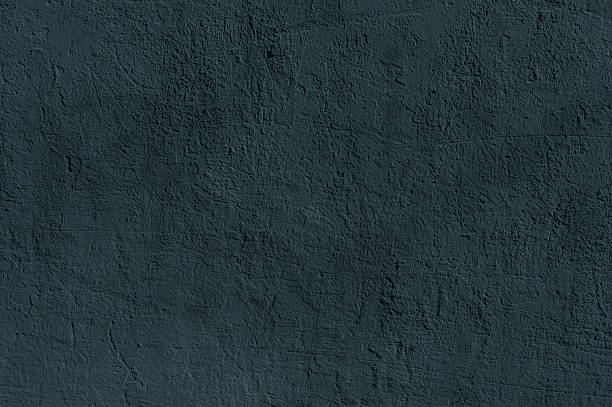 A textured dark blue wall creates a visually striking and versatile background with a rough surface.