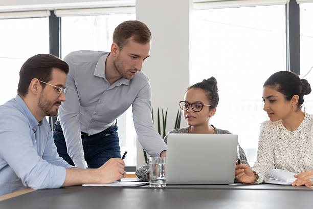 istock Multiethnic employees use laptop discussing project together 2206809659