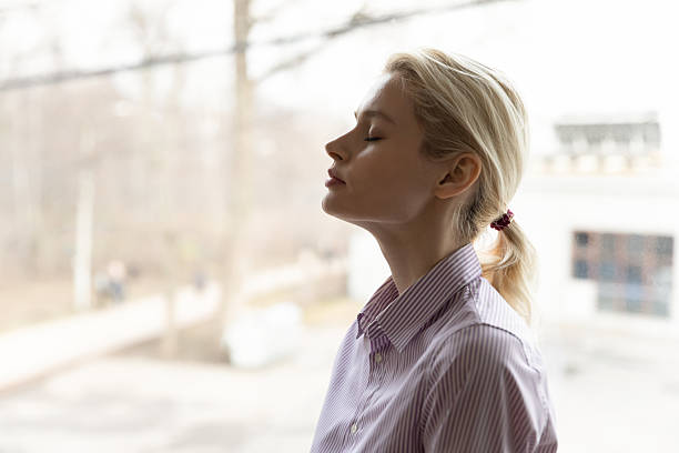 istock Calm young woman breathe fresh air meditating 2206810136