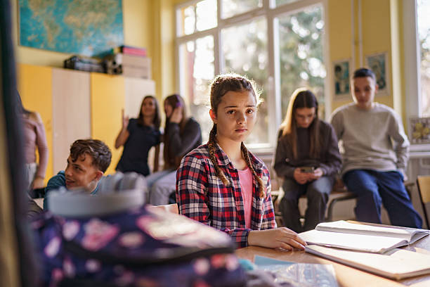 Schoolgirl feeling depressed while sitting alone during the break