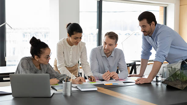 istock Multiracial colleagues discuss company paperwork in meeting 2206811415