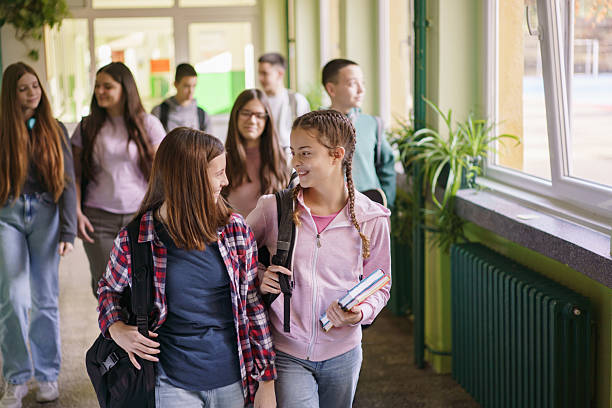 istock Girls talking in school corridor 2206812405