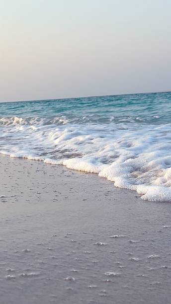 istock Tranquil tropical beach waves gently wash sandy shore creating perfect seascape for relaxation. This serene scene captures essence of natural beauty beach relaxation, offering peaceful escape. 2206812673