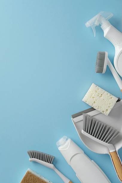 istock Cleaning supplies placed on a vibrant blue background. Includes brushes, sponges, a spray bottle, and dustpan. Perfect for promoting household cleaning or hygiene products 2206812855