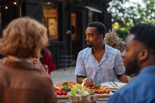 istock Friends enjoying dinner together on a summer evening 2206812897