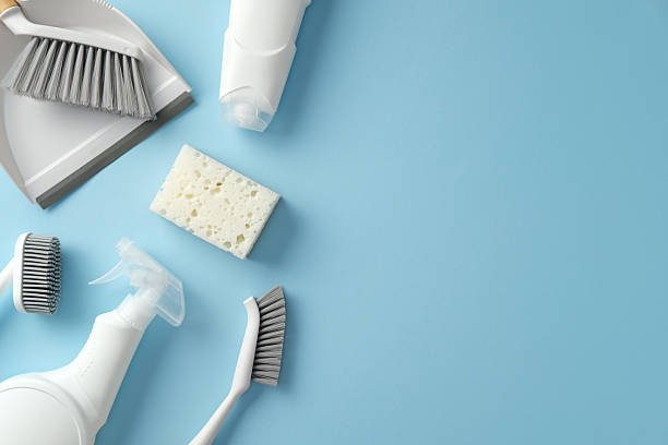 istock Household cleaning items on a bright blue background: dustpan, brushes, sponge, and spray bottle. Perfect for promoting cleaning products, hygiene, or home organization 2206813688