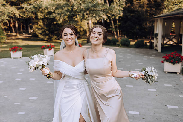 istock Two women are smiling and holding flowers 2206813989