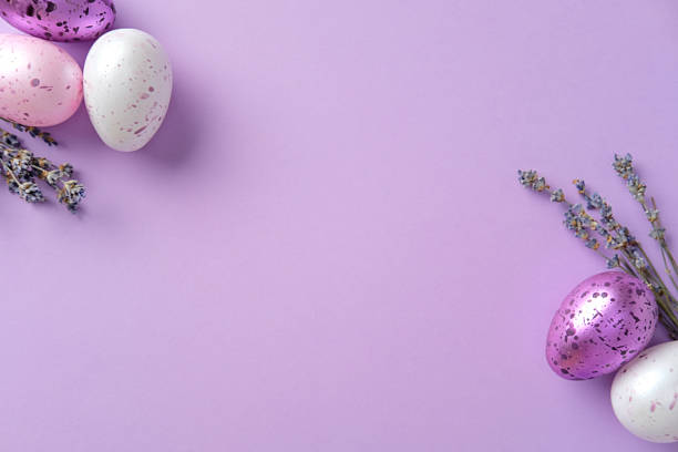 Easter frame of eggs painted in purple color and lavender. Easter greeting card template. Flat lay, top view, copy space.