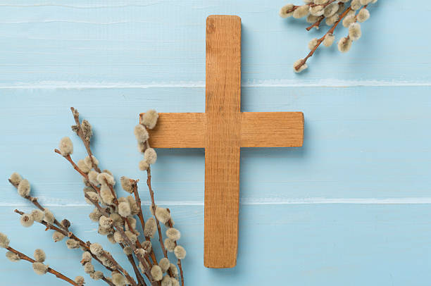 istock Cross with willow branches on wooden background, top, view. Palm Sunday concept 2206814439