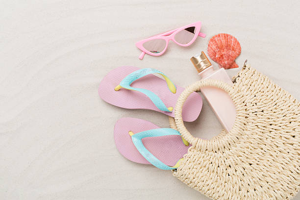 istock Straw bag with accessories on sand background, top view 2206814854