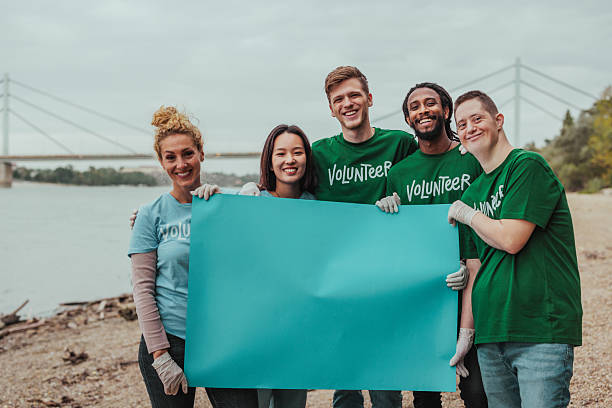 istock Volunteers holding blank placard by the river 2206815034