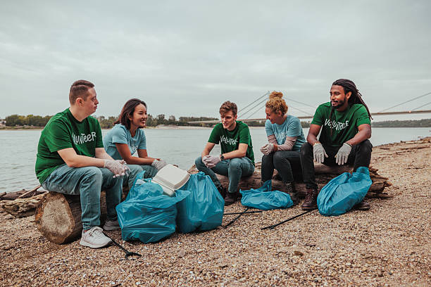 istock Volunteers cleaning the riverbank from plastic waste 2206815037