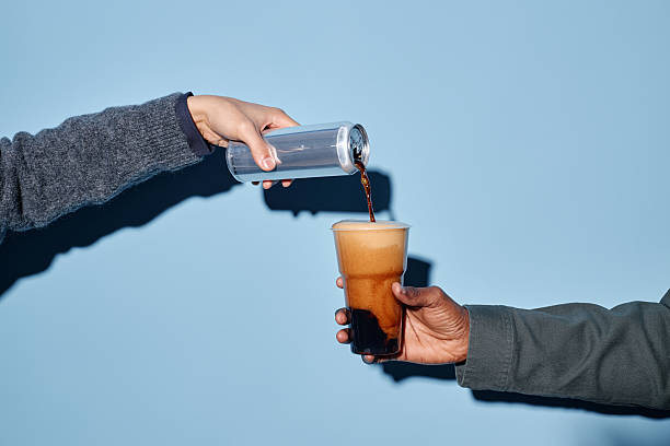 istock Pouring and Serving Dark Beer from Can with Blue Background 2206816458
