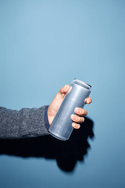 istock Holding Metallic Beverage Can Against Blue Background 2206816463