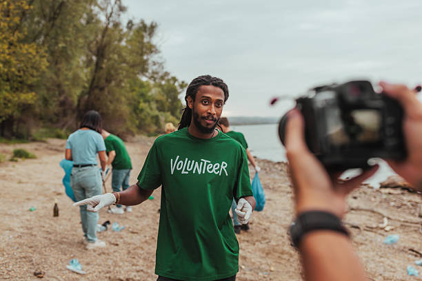 istock Volunteer pointing at garbage on the riverbank during a cleanup event 2206816766