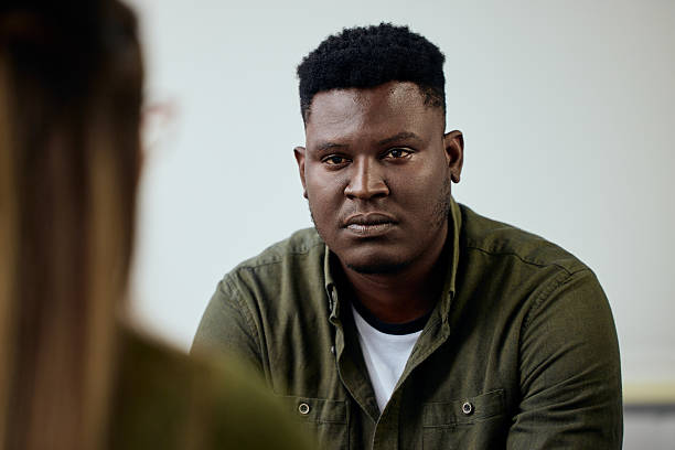 Man in Casual Shirt Having a Serious Conversation with Another Person