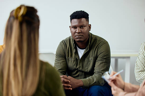 istock Young Man Attending Group Therapy Session Focused on Personal Growth and Support 2206817593