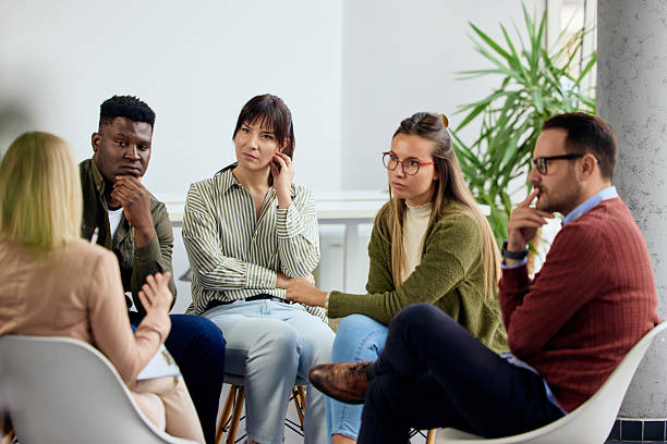 Diverse Group Engaged in a Collaborative Discussion in a Modern Setting stock photo