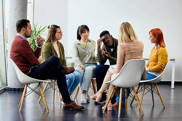 istock Group Therapy Session With Support Circle of People Discussing Stories and Emotions 2206817617