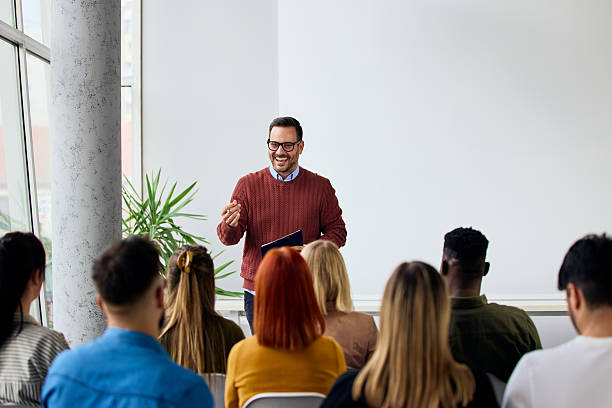 Professional Speaker Conducting Corporate Training Session for Engaged Employees in a Modern Office