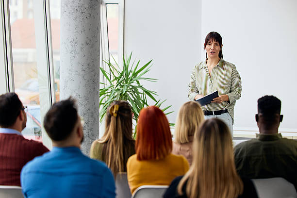 istock Speaker Presenting to an Engaged Audience in a Bright Conference Setting 2206817631