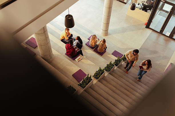 istock University students studying and walking in a modern building 2206817755