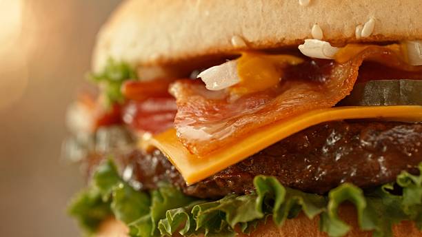 istock Delicious cheeseburger with cheese, lettuce, tomato, red onion and bun. 2206818580