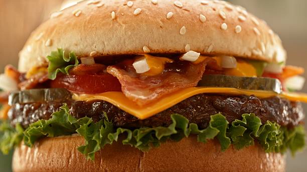 istock Delicious cheeseburger with cheese, lettuce, tomato, red onion and bun. 2206818603