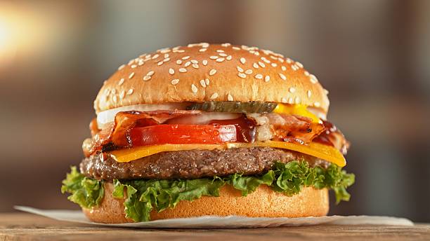 istock Delicious Hamburger Served on Wooden Table. 2206818773