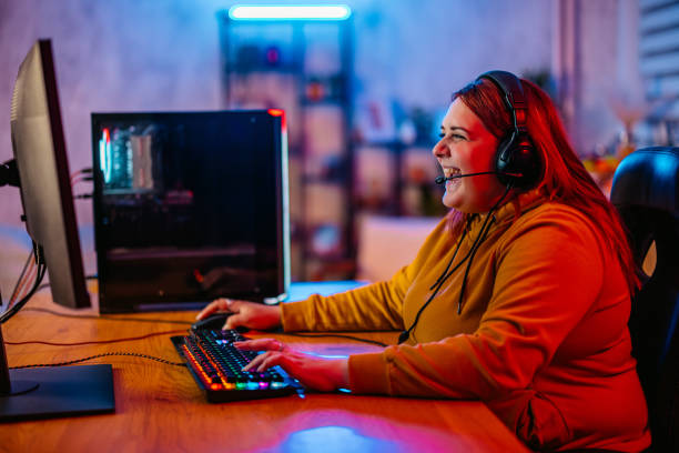 istock Young Woman Playing A Video Game On Her Desktop PC 2206820625